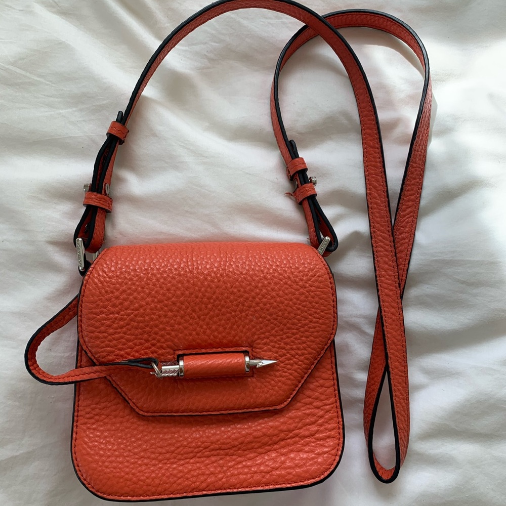 Orange mackage cross body arrow bag